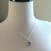 Our new mommy wax seal necklace around a mannequin.