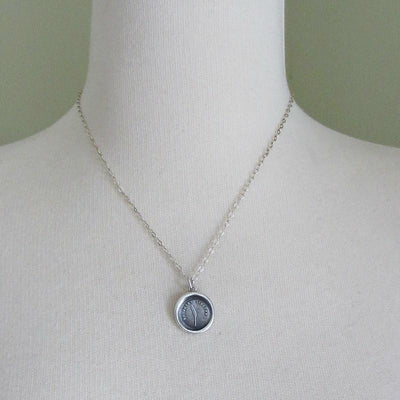 Always Sincere wax seal necklace around mannequin