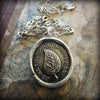 Bronze leaf wax seal charm with the phrase I Change Only In Death