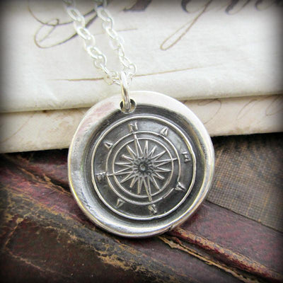 Compass wax seal over an antique book