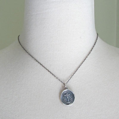 Crucifixion of Christ silver wax seal necklace around mannequin