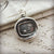 Love turns everything upside Down cupid wax seal necklace.