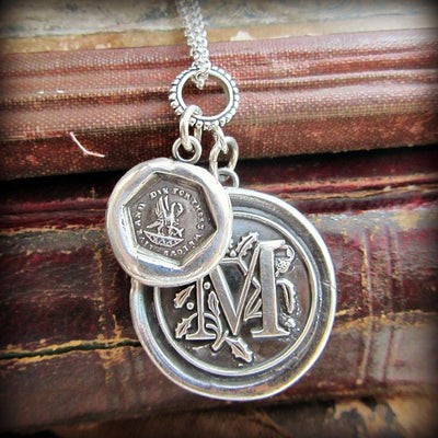 A mother's love personalized wax seal medallion over a stack of old books.