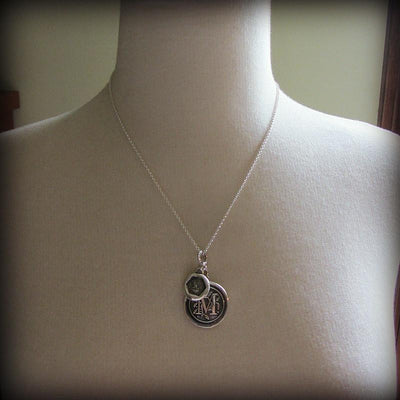 This personalized wax seal medallion is wrapped around a mannequin and expresses a mother's love.