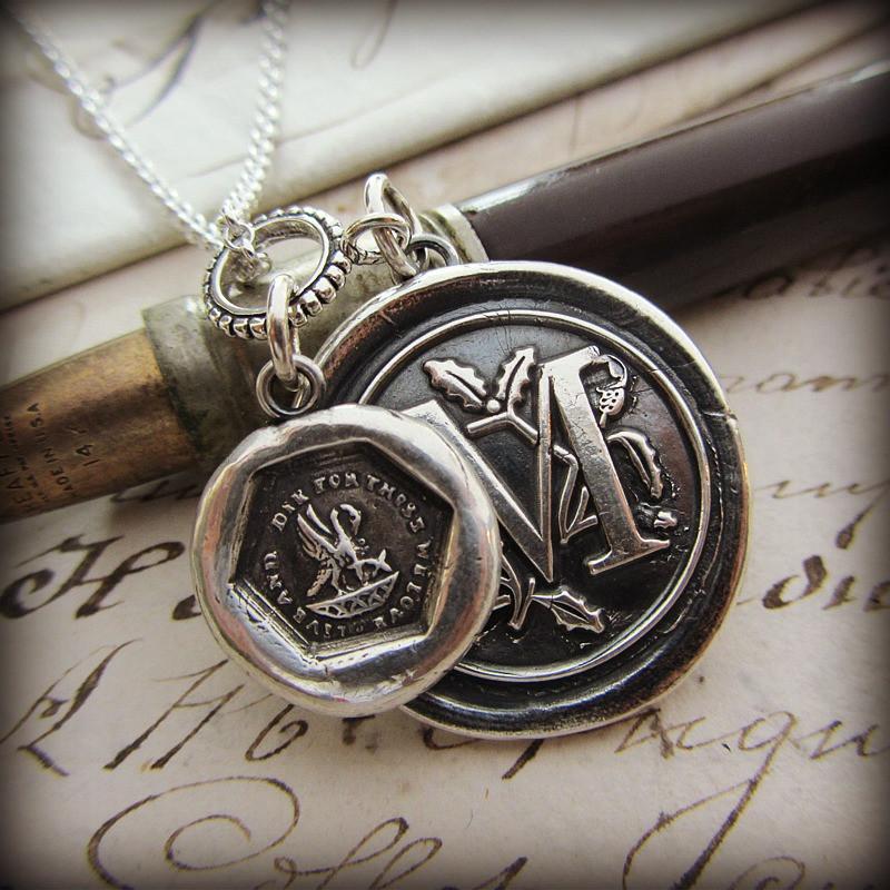Our personalized Wax Seal Medallion with the letter M on it with old english in the background.