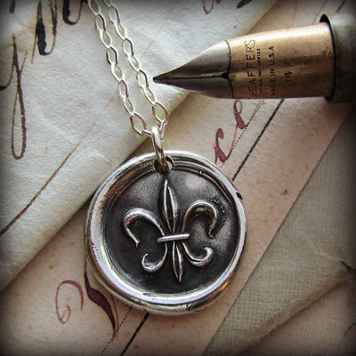 Fleur De Lis Vintage Wax Seal necklace with a fine tipped old style pen.