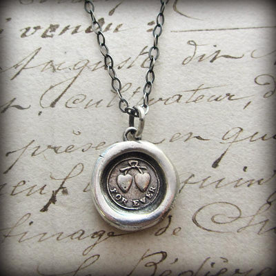 Forever Victorian Wax Seal Necklace over old english script