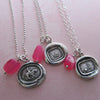 Hot pink chalcedony nugget charms attached to wax seal necklaces.