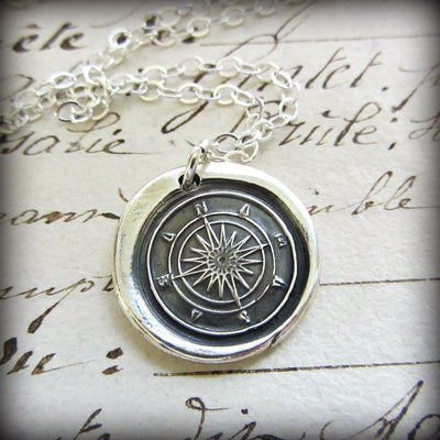 Compass Wax Seal with a silver chain lying on old english script