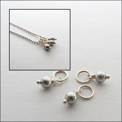 Three swarovski silver pearls and a close up of the three on a stainless steel chain.