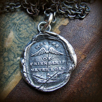 Winged wax seal pendant with the motto May the Wings of Friendship Never Lose a Feather